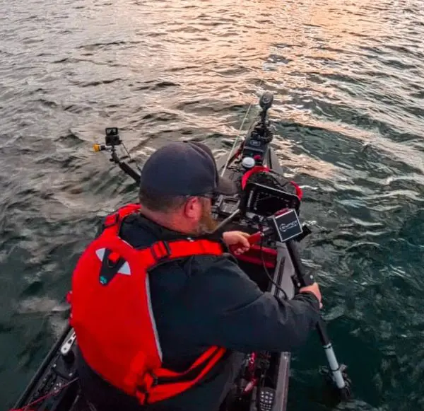 Kayaker with fishing gear on water