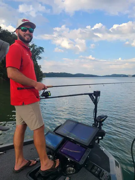Man fishing on a boat with electronics