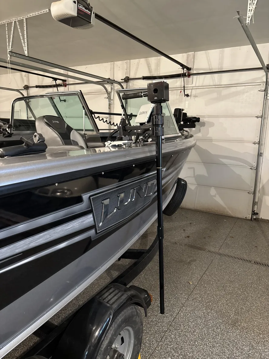 Fishing boat in garage with camera setup.
